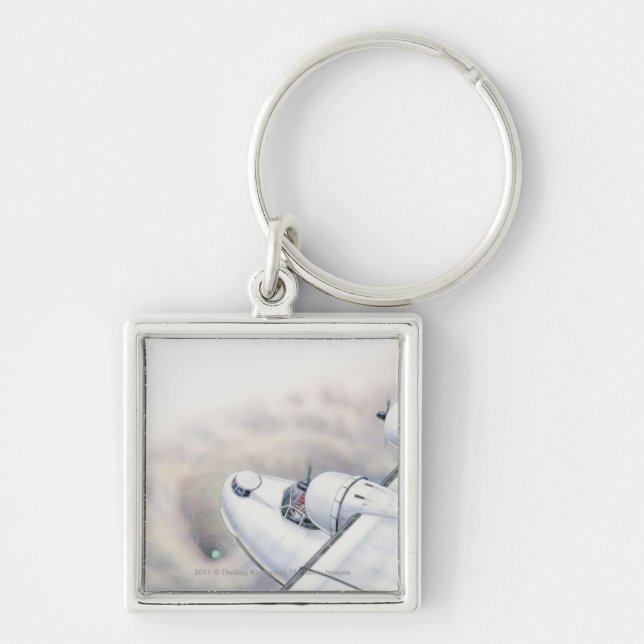 Illustration of a plane flying above wormhole key ring (Front)