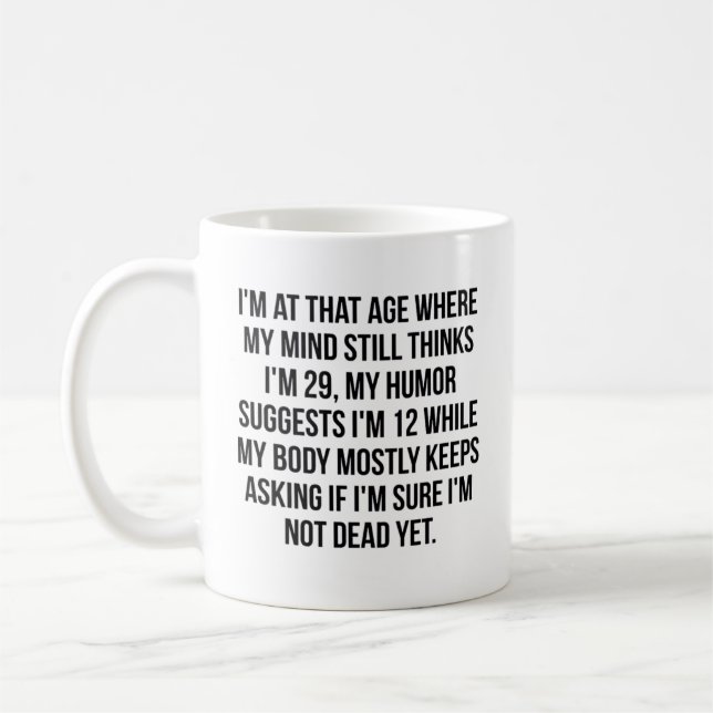 I'M AT THAT AGE WHERE MY MIND STILL THINKS I'M 29, COFFEE MUG (Left)