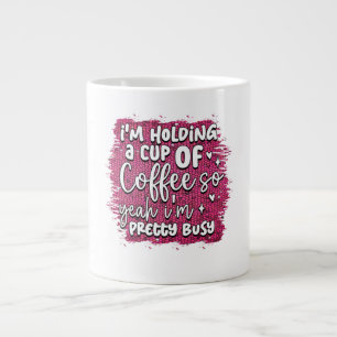 Im holding a cup of coffee so