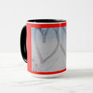 imprint of two hearts drawn in the snow on a mug
