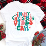 In My Christmas Vibes Era Retro Christmas Tri-Blend Shirt<br><div class="desc">Celebrate the holiday season in style with this "In My Christmas Vibes Era" retro Christmas shirt! Featuring groovy typography in festive colours, this design captures the fun, nostalgia, and excitement of the holidays. Perfect for anyone who loves combining vintage aesthetics with modern trends, this shirt is ideal for Christmas parties,...</div>
