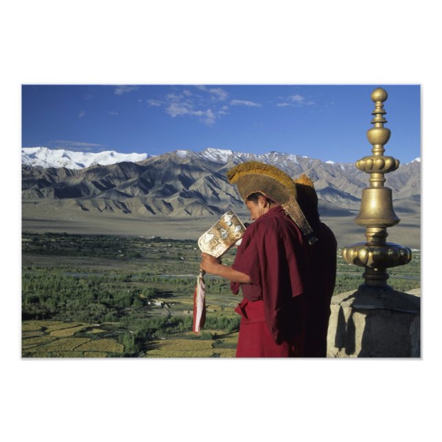 India, Ladakh, Thikse. Buddhist monk blows Photo Print (Front)