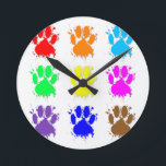 Ink Splatter Dog Paw Pattern Round Clock<br><div class="desc">A colorful pattern of dog paw prints with ink splatter effect.</div>