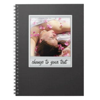 instant photo - photoframe - on black spiral notebook
