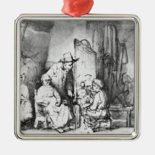 Interior of studio with painter painting metal tree decoration