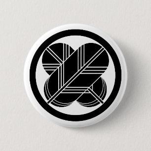Intersecting hawk feathers with foot in circle 6 cm round badge