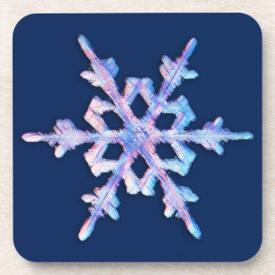 Iridescent snowflake on dark blue coaster