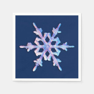 Iridescent snowflake on dark blue napkin