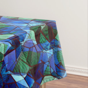 Irregular and disorganised mosaic overlaid blue tablecloth