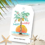 Island Holiday Palm Tropical Beach Christmas Gift Tags<br><div class="desc">Tropical beach theme gift tags feature an island in the sun with a palm tree decorated with string lights and ornaments,  a "happy holidays" greeting. and a line of text that you can personalise. Art by KL Stock</div>