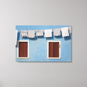Italy, Burano. Hanging laundry and windows along Canvas Print