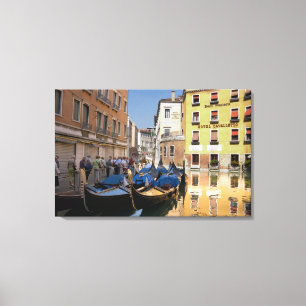 Italy, Venice, gondolas moored along canal Canvas Print