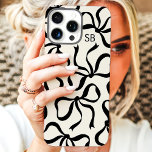 Ivory And Black Bow Monogram iPhone 16 Pro Max Case<br><div class="desc">Dress up your phone in style with this chic and trendy ivory and black phone case! Featuring a playful pattern of hand-drawn bows and personalised with your monogram, this case is the perfect blend of fashion and function. Made from durable materials to protect your phone from everyday bumps and scratches....</div>