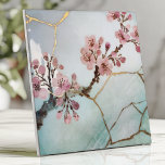 Japanese Watercolor Cherry Blossom Kintsugi Tile<br><div class="desc">Elevate your space with this Japanese-inspired tile featuring delicate cherry blossom branches in soft pink watercolor on a serene light blue background. The design is enhanced with gold Kintsugi-style cracks, symbolising the art of finding beauty in imperfection. Perfect for creating tranquil backsplashes, accent walls, or decorative projects, this tile’s organic...</div>