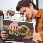 Jazzman Playing Gold Saxophone Planner<br><div class="desc">For jazz music fans! This monthly/weekly calendar planner keeps all your up-coming activities and schedules organized in one, handy place and features the photo image of a jazzman playing his time-worn, gold colored, tenor saxophone horn along with the word "JAZZ" printed in gold colored block letters. Select your planner style,...</div>