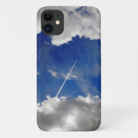 Jet plane trails between clouds