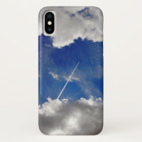 Jet plane trails between clouds