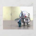 Jo Bot VS Little Blue Bot Postcard<br><div class="desc">A huge metalic robot sneaks up behind a smal blue wind up robot</div>