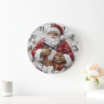 Joyful Santa with gifts celebrating! Large Clock<br><div class="desc">A cheerful Santa Claus adorned in his iconic red suit holds a beautifully wrapped gift,  radiating festive joy. Surrounded by snowy ornaments,  he embodies the spirit of Christmas,  inviting warmth and happiness during this magical season.</div>