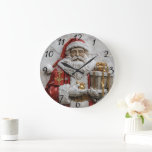 Joyful Santa with gifts Large Clock<br><div class="desc">This enchanting depiction captures Santa Claus,  joyfully presenting a beautifully wrapped gift in one hand while the other clutches a shiny ornament. Adorned in his classic red outfit accented with white fur,  he radiates holiday cheer.</div>