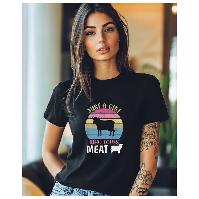 Just A Girl Who Loves Meat Carnivore Diet T-Shirt (A woman wearing a black t-shirt with the image of a cow, and the words "Just a Girl who loves meat")
