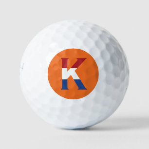 K Monogram overlaid on NLD Flag on or be6 gbcnt Golf Balls