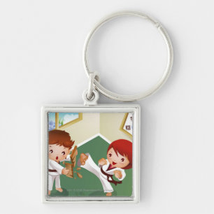 Karate boy holding wood with another breaking it key ring
