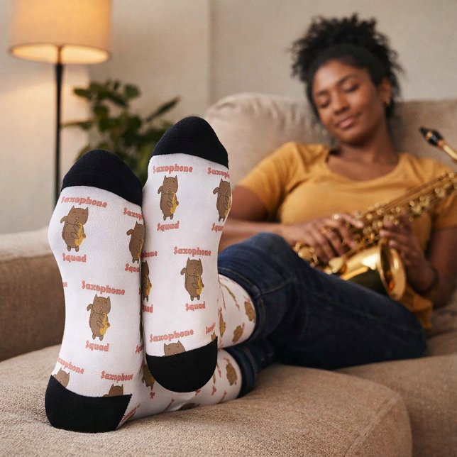 Kawaii Cat Playing Saxophone Squad Music Socks (A pair of socks with a cat playing the saxophone and the text saxophone squad in pink letters.)