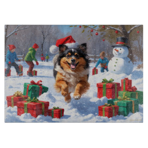 Keeshond Dog Running in Snow with Christmas Hat Cutting Board