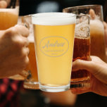 Khaki Stylised Wedding Groomsman Name Glass<br><div class="desc">Beer glass for the wedding groomsman that features his name printed in a trendy khaki colour, stylised script inside a khaki colour oval border along with wedding date. A great party supply idea for a bachelor party! Personalise your beer glass by editing and replacing name and date with your own....</div>