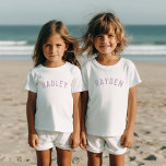Kids Personalised Name Tee | Lilac<br><div class="desc">These personalised children's t-shirts feature your child's name or other custom text in a stylish, modern arched font, adding a playful and unique touch to their wardrobe. Made from soft, high-quality fabric, these custom tees are perfect for everyday wear, special occasions, or as a thoughtful gift. Let your little one...</div>
