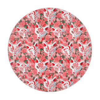 Kitsune masks and blooming camellia on pink cutting board