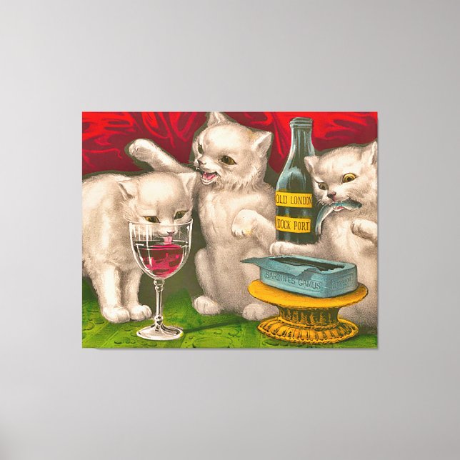 Kittens drinking and eating sardine fish canvas print (Front)