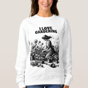 kneels in a garden sweatshirt