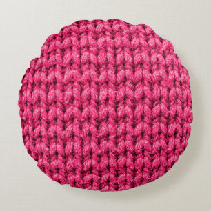 Knitted pink background. Yarn texture. Vertical kn Round Cushion