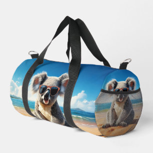 Koala on a sandy beach duffle bag