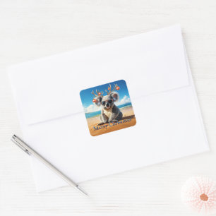 Koala on beach wearing Antlers and baubles Square Sticker