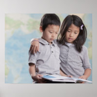 Korean children reading book near map