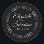 Lacy Silver Filigree Elegant Black Wedding Classic Round Sticker<br><div class="desc">These elegant wedding stickers feature fancy pale grey script text on a black background with a lacy silver faux foil floral border. The text is fully customisable and contains the wedding couple's names and wedding date. Great as favour tags or envelope seals!</div>