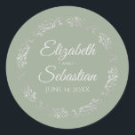 Lacy Silver Filigree Elegant Sage Green Wedding Classic Round Sticker<br><div class="desc">These elegant wedding stickers feature fancy pale grey script text on a sage green coloured background with a lacy silver faux foil floral border. The text is fully customisable and contains the wedding couple's names and wedding date. Great as favour tags or envelope seals!</div>