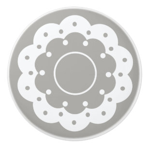 Lacy white cutout doily look on grey ceramic knob