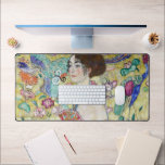 Lady with A Fan, Gustav Klimt Desk Mat<br><div class="desc">Gustav Klimt (July 14, 1862 – February 6, 1918) was an Austrian symbolist painter and one of the most prominent members of the Vienna Secession movement. Klimt is noted for his paintings, murals, sketches, and other objets d'art. In addition to his figurative works, which include allegories and portraits, he painted...</div>