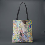 Lady with A Fan, Gustav Klimt Tote Bag<br><div class="desc">Gustav Klimt (July 14, 1862 – February 6, 1918) was an Austrian symbolist painter and one of the most prominent members of the Vienna Secession movement. Klimt is noted for his paintings, murals, sketches, and other objets d'art. In addition to his figurative works, which include allegories and portraits, he painted...</div>