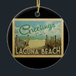 Laguna Beach Vintage Travel Ceramic Tree Decoration<br><div class="desc">This Greetings From Laguna Beach vintage postcard design features a sandy beach with a beautiful turquoise ocean water and above the sea,  a blue sky with billowy white clouds. In vintage travels style.</div>