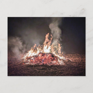 Large bonfire burning at night with high flames postcard