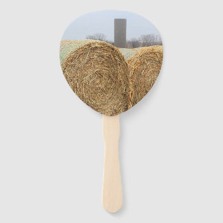 Large Round Hay Bales in a Farm Field Hand Fan