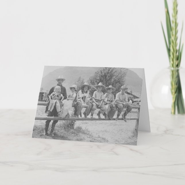Larry Larom with six children on a fence. Card (Front)