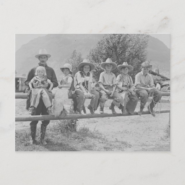 Larry Larom with six children. Postcard (Front)