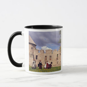 Latvian girls in traditional dress, singing mug