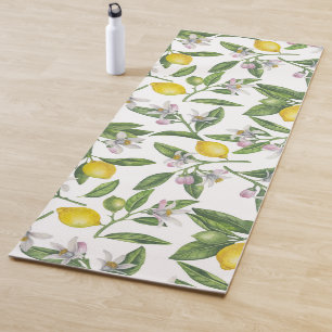 Lemon branches with blossoms and fruit on white yoga mat